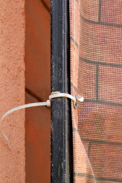 istock Close up of binding of construction mesh to scaffolding with plastic cable tie 1060492666