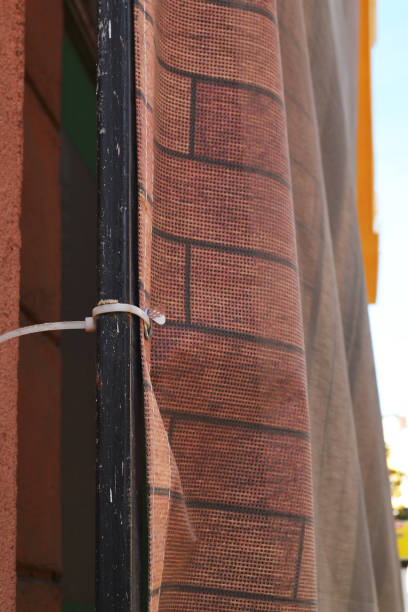 istock Close up of binding of construction mesh to scaffolding with plastic cable tie 1060492670