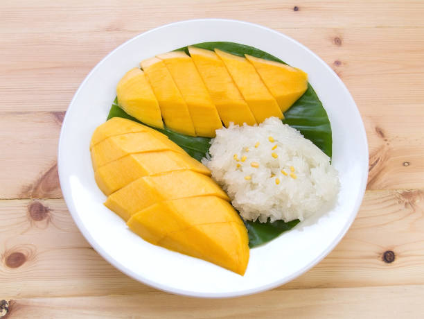 istock Mango sticky rice. Thai style dessert, mango with glutinous rice on wooden table background. 1060495592