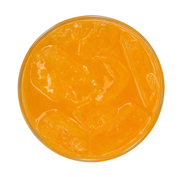 istock Orange juice with ice cubes top view isolated on white background 1060495896