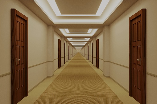 A deep corridor with closed blue doors on either side