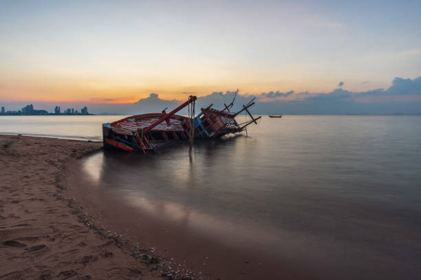 istock Shipwreck on the beach at sunset 1060502856