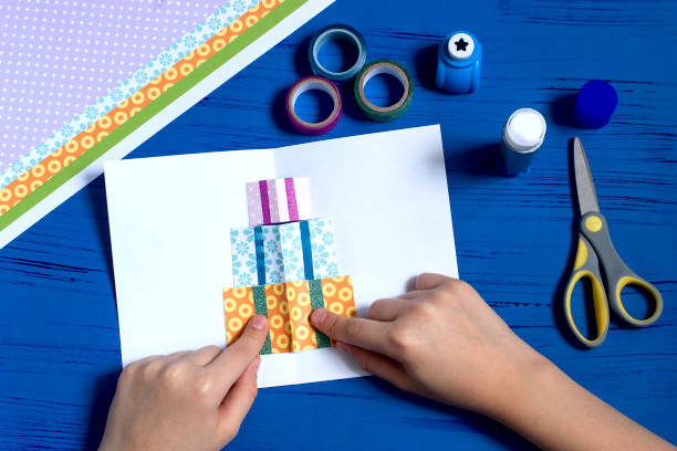 istock Child makes a card for Christmas. Step 8 1060507454