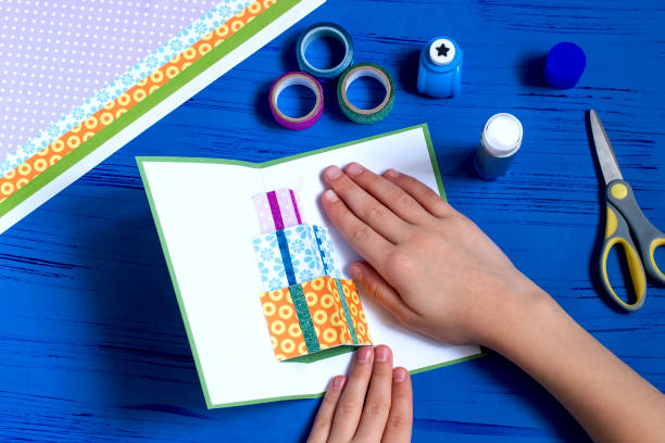 istock Child makes a card for Christmas. Step 9 1060507470