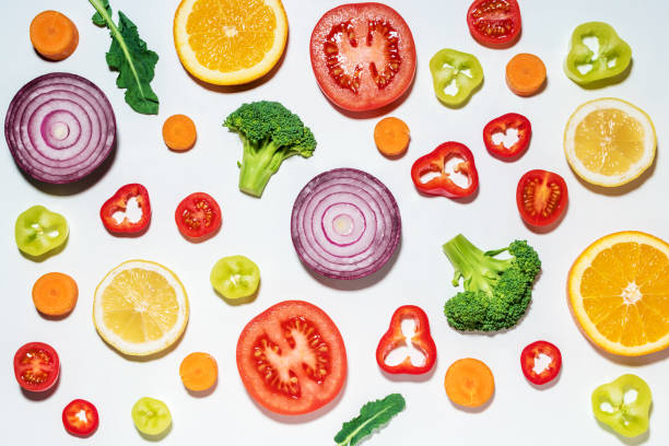 istock Assorted sliced vegetables and fruits on white background.  Flat 1060508110