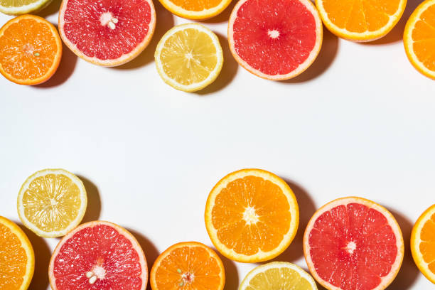 istock Assorted sliced fruits on white background.  Flat lay. Food vega 1060508184