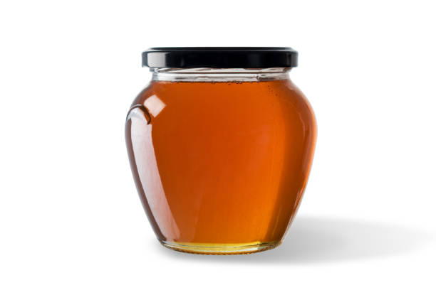 istock Honey in jar isolated on white background. 1060508218