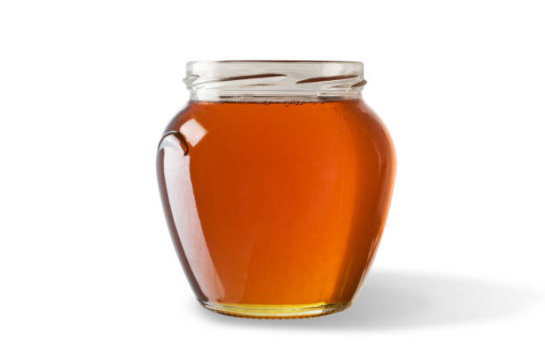 istock Honey in jar isolated on white background. 1060508224