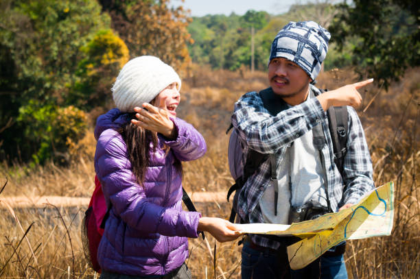 istock Asian travelers holding map and argue in forest 1060509540