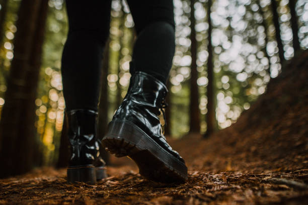 istock Rear view of women boots in a forest 1060512604
