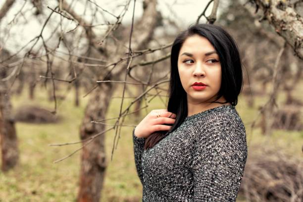 istock Plump girl on a cold spring walk 1060516040