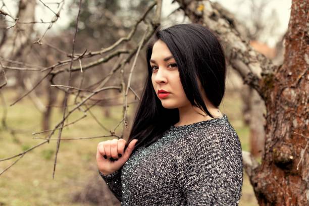 istock Plump girl on a cold spring walk 1060516046
