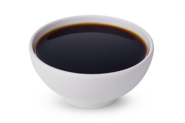 A tasty black soy sauce in bowl isolated on white background A tasty soy sauce in bowl isolated on white background soy sauce photos stock pictures, royalty-free photos & images