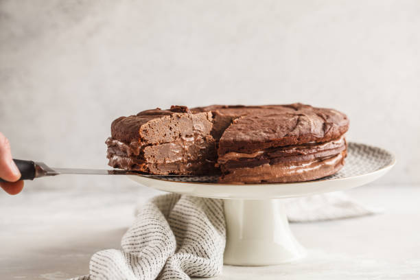 istock Vegan chocolate cake on a white dish for cake, copy space, light background. 1060517720