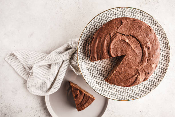 istock Vegan chocolate cake on a white dish for cake, top view, copy space. 1060517990