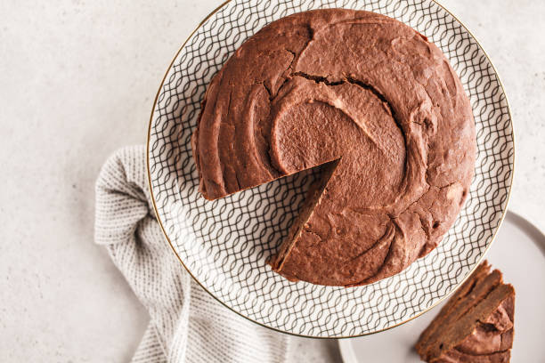 istock Vegan chocolate cake on a white dish for cake, top view, copy space. 1060518110