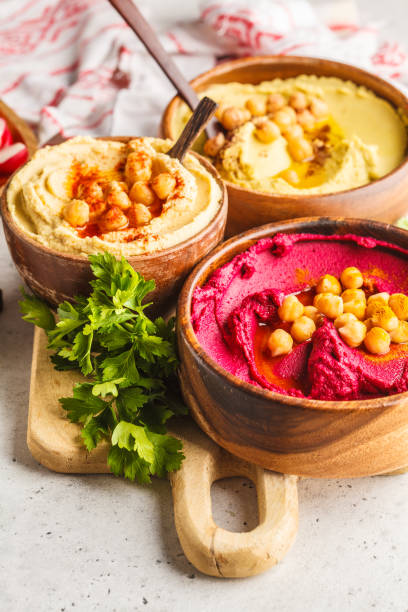 istock Different hummus bowls. Chickpea hummus, avocado hummus and beetroot hummus. 1060519840