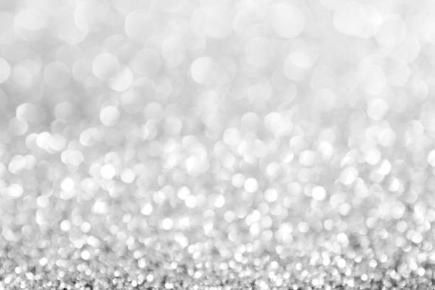 istock abstract background white Silver lights on christmas bokeh 1060521052