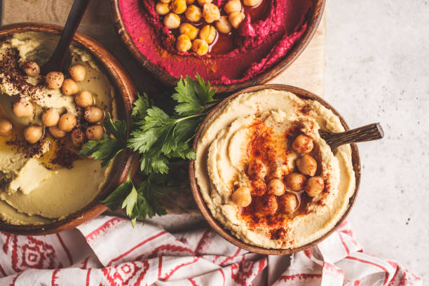 istock Different hummus bowls. Chickpea hummus, avocado hummus and beetroot hummus, top view. 1060521430