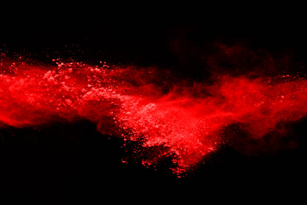 istock abstract red powder explosion on black background.abstract red powder splatted on black background. Freeze motion of red powder exploding. 1060521484