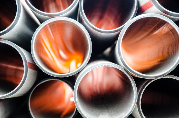 Background image, stacked plastic pipes in the backlight stock photo