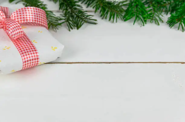 Christmas presents with a spruce twig and decorations on a white background