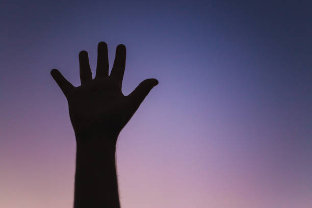 istock silhouette of two hands against sky 1060522678