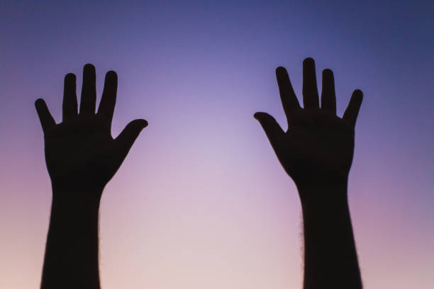 istock silhouette of two hands against sky 1060522690