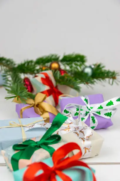 Christmas presents with a spruce twig and decorations on a white background