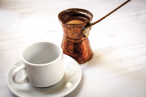 istock Greek or Turkish coffee in its briki next to a cup 1060532096
