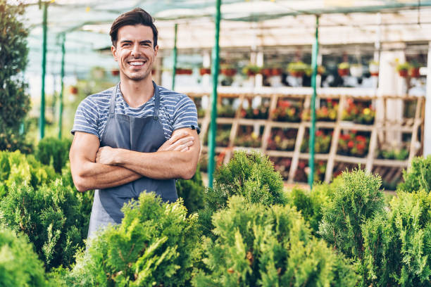 istock Smiling gardener with evergreen trees 1060532406