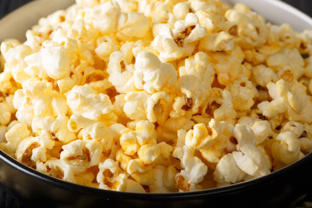 istock Tasty popcorn with cheese cheddar and parmesan in a bowl macro. horizontal 1060532568