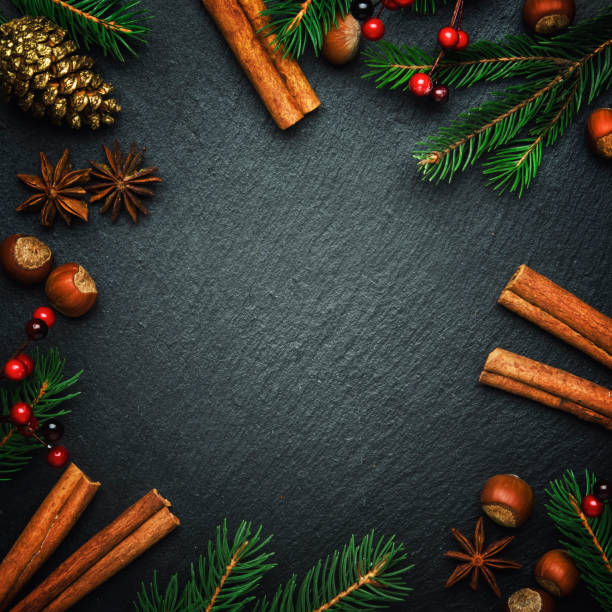 Christmas or New Year dark background, frame, template, with festive decorations, winter spices and Christmas decorations