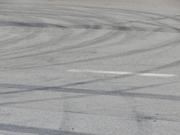 istock Car tire stains on asphalt racing cards 1060535010