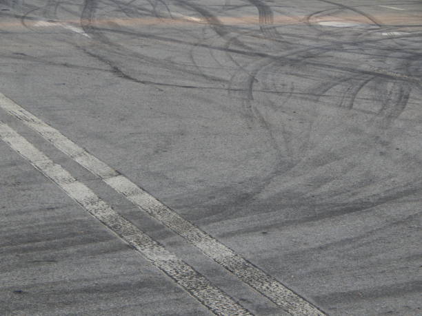 istock Car tire stains on asphalt racing cards 1060535030