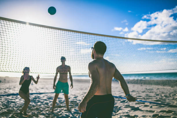istock Group Of People Playing Beach Volleyball During a Vacation 1060539336