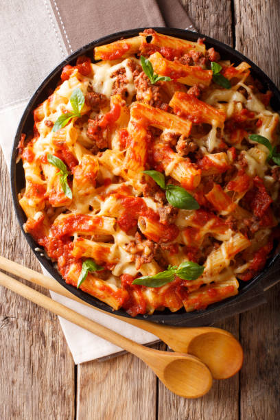 istock Delicious pasta with ground beef, tomatoes and cheese close-up. Vertical top view 1060547462