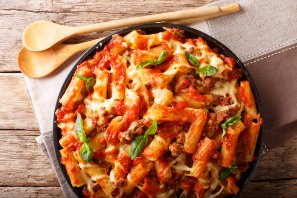 istock Delicious pasta with ground beef, tomatoes and cheese close-up. Horizontal top view 1060548088