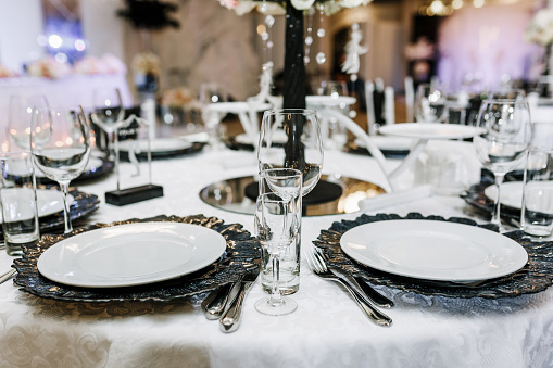 Wedding elegant table setting. Black & white color palette catering party.