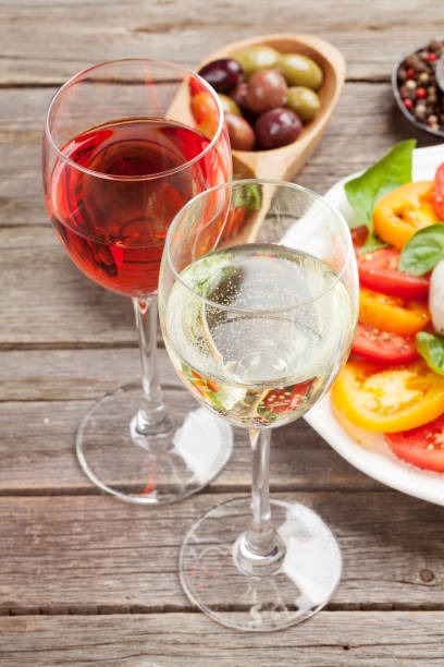 istock White and rose wine glasses with caprese salad 1060550804