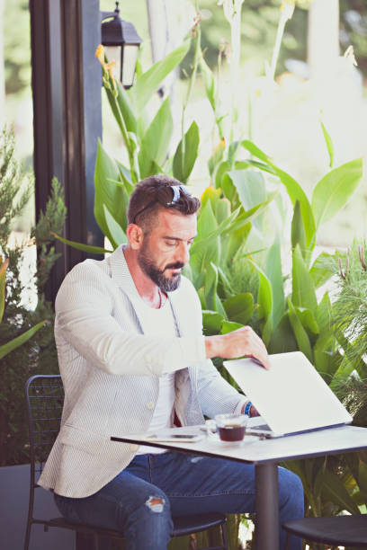 istock Young man working with laptop in a cafe 1060552520