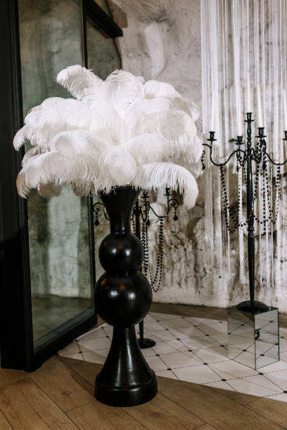 White ostrich feather in black vase, wedding decoration details White ostrich feather in black vase, wedding decoration details. ostrich feather stock pictures, royalty-free photos & images