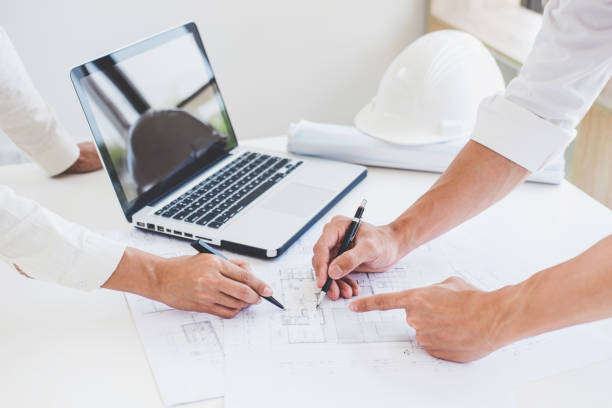 istock Architect or Engineer meeting working with partner on blueprint for architectural project in progress, construction and structure concept 1060555230