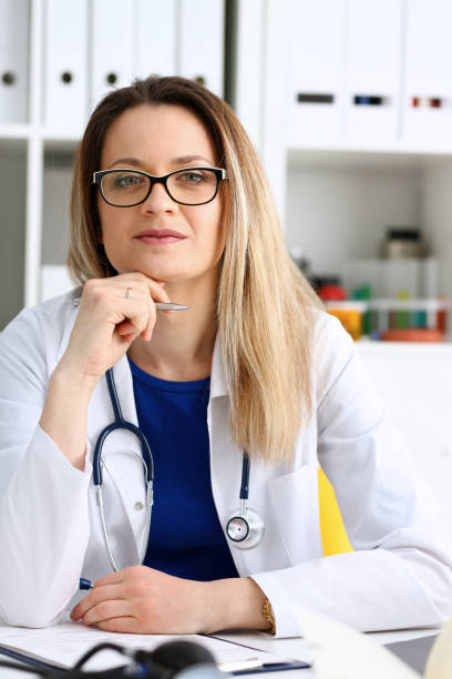 istock Beautiful smiling female doctor sit at workplace 1060555406