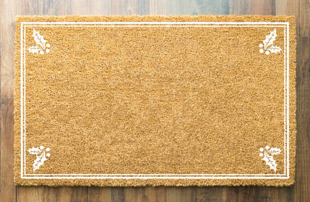 istock Blank Holiday Welcome Mat With Holly On Wood Floor Background 1060557422
