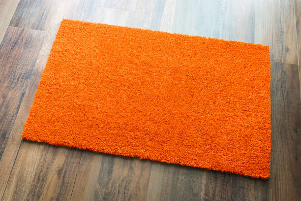 istock Blank Orange Welcome Mat On Wood Floor Background Ready For Your Own Text 1060557442