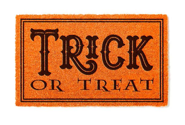istock Trick Or Treat Halloween Orange Welcome Mat Isolated on White Background 1060557784