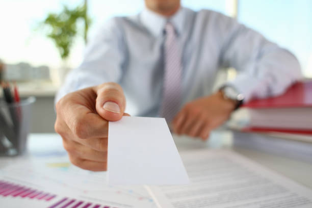 istock Male arm in suit give blank calling card 1060558180