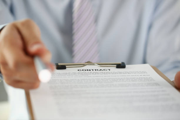 istock Male arm in suit offer contract form on 1060558280
