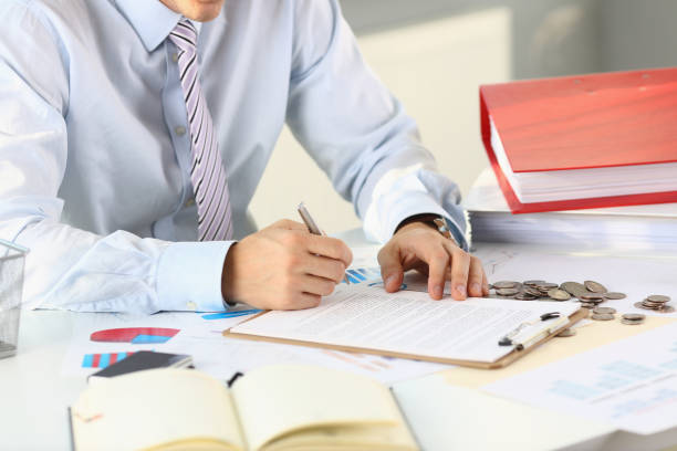 istock Male arm in suit and tie hold silver 1060558556